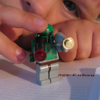 Leo holds a Lego Boba Fett figure
